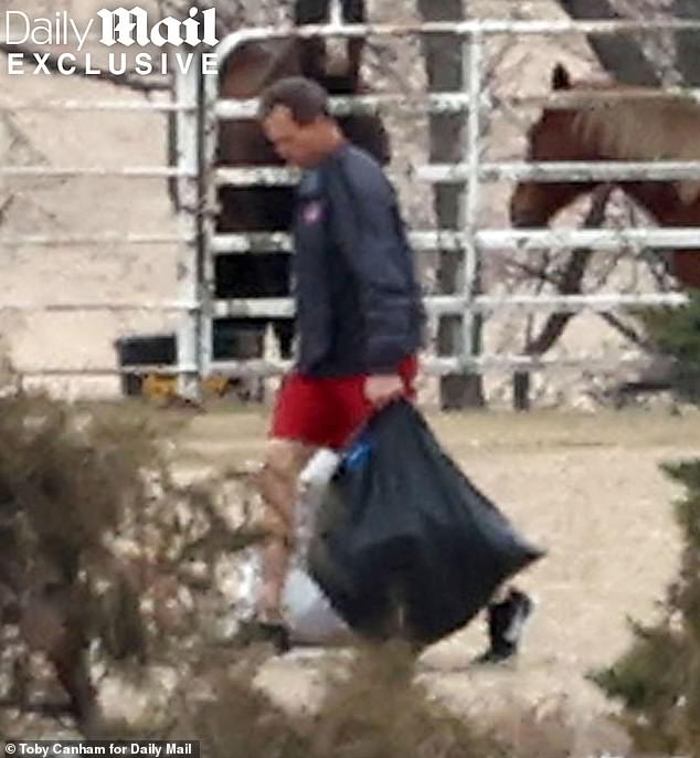 Kristi Noem's husband Bryon keeps his head down as he's seen for the first time at family ranch since cross-dressing scandal bombshell
